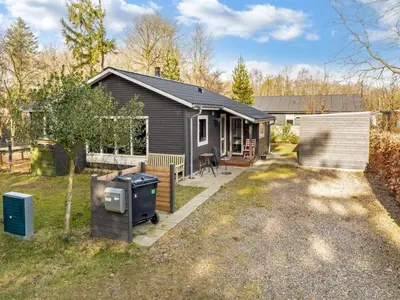 a small house with a grill in a yard at Holiday Home Milan - 250m to the fjord by Interhome in Thyholm