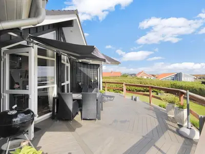 a patio with a table and chairs on a deck at Holiday Home Eberta - 200m to the fjord by Interhome in Vinderup