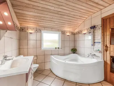 a large bathroom with two sinks and a tub at Holiday Home Loviisa - 300m to the fjord by Interhome in Vinderup