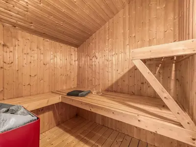 a wooden sauna with a bench in the middle at Holiday Home Loviisa - 300m to the fjord by Interhome in Vinderup