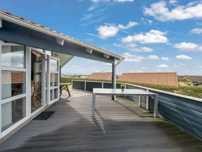 a wooden deck with a bench on top of a house at Holiday Home Loviisa - 300m to the fjord by Interhome in Vinderup