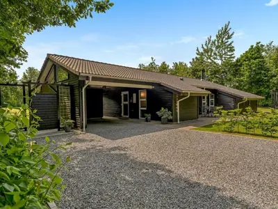 a house with a gravel driveway in front of it at Holiday Home Yorrit - 500m to the fjord by Interhome in Højslev