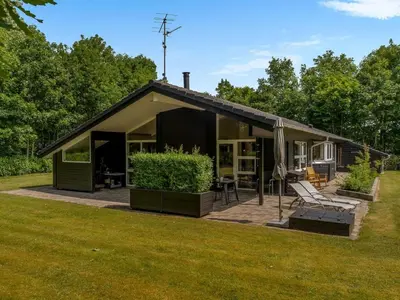 a small black house with a lawn at Holiday Home Yorrit - 500m to the fjord by Interhome in Højslev