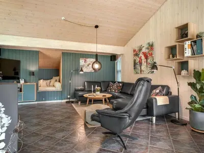 a living room with a couch and a table at Holiday Home Yorrit - 500m to the fjord by Interhome in Højslev