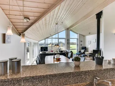 an open kitchen and living room with wood ceilings at Holiday Home Alboldus - 250m to the fjord by Interhome in Vinderup