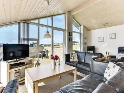 a living room with a couch and a tv at Holiday Home Alboldus - 250m to the fjord by Interhome in Vinderup