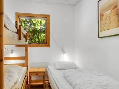 a bedroom with two bunk beds and a window at Holiday Home Anine - 200m to the fjord by Interhome in Højslev