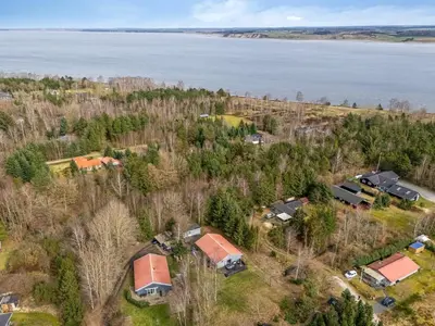 an aerial view of a house with trees and the water at Holiday Home Anine - 200m to the fjord by Interhome in Højslev