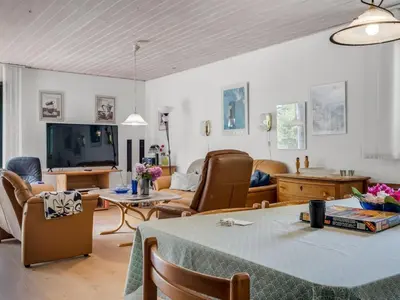 a living room with a table and a couch at Holiday Home Anine - 200m to the fjord by Interhome in Højslev