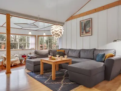 a living room with a couch and a table at Holiday Home Flugha - 500m to the fjord by Interhome in Thyholm