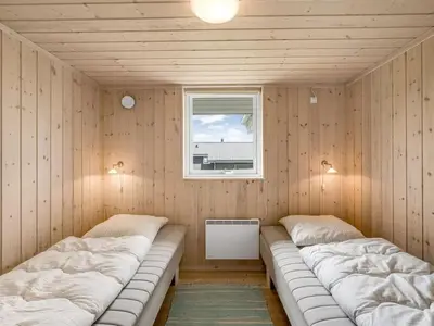 a room with two beds in a room with a window at Holiday Home Lucio - 350m to the fjord by Interhome in Vinderup