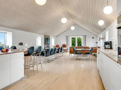a kitchen and dining room with a table and chairs at Holiday Home Folkar - 3km to the fjord by Interhome in Thyholm