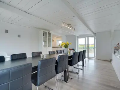 a dining room with a long table and chairs at Holiday Home Ailke - 2km to the fjord by Interhome in Thyholm