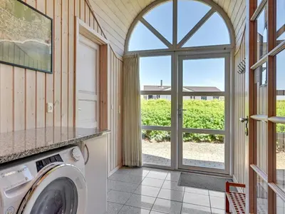a washer and dryer in a room with a window at Holiday Home Guthmar - 350m to the fjord by Interhome in Vinderup
