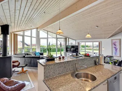 a kitchen with a sink and a living room at Holiday Home Guthmar - 350m to the fjord by Interhome in Vinderup