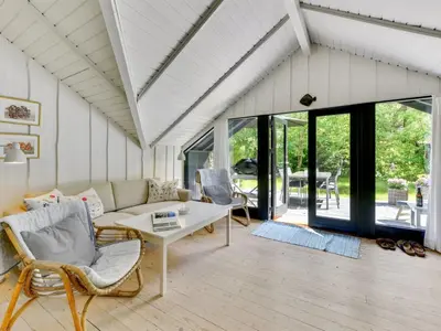 a living room with a couch and a table at Holiday Home Alika - 200m to the fjord by Interhome in Thyholm