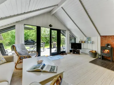 a living room with a couch and a table at Holiday Home Alika - 200m to the fjord by Interhome in Thyholm