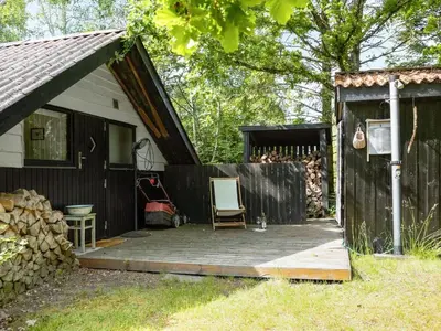 a house with a wooden deck next to a fence at Holiday Home Alika - 200m to the fjord by Interhome in Thyholm