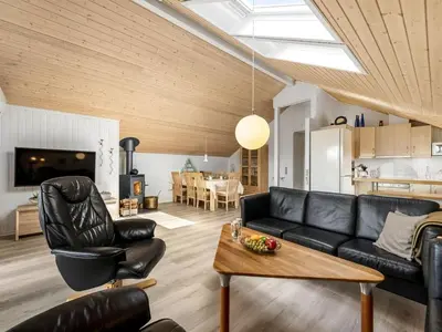a living room with a couch and a table at Holiday Home Naninja - 300m to the inlet by Interhome in Vinderup