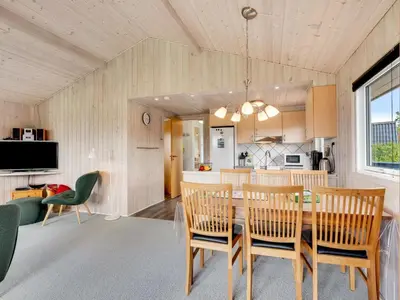 a dining room and kitchen with a table and chairs at Holiday Home Titta - 150m to the fjord by Interhome in Vinderup
