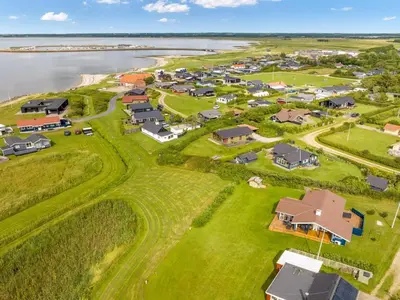 an aerial view of a village next to the water at Holiday Home Titta - 150m to the fjord by Interhome in Vinderup