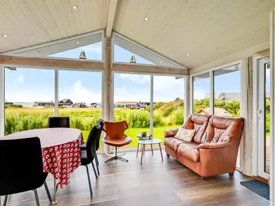 a living room with a couch and a table at Holiday Home Titta - 150m to the fjord by Interhome in Vinderup