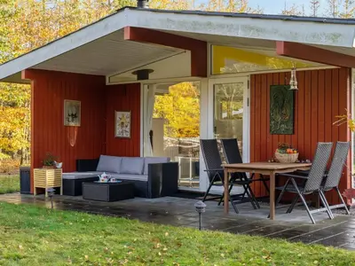 a covered patio with a couch and a table at Holiday Home Calli - 400m to the fjord by Interhome in Højslev