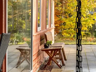 a porch with a bench and a window at Holiday Home Calli - 400m to the fjord by Interhome in Højslev