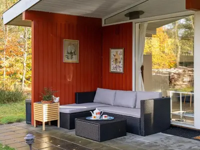 a patio with a couch and a table at Holiday Home Calli - 400m to the fjord by Interhome in Højslev