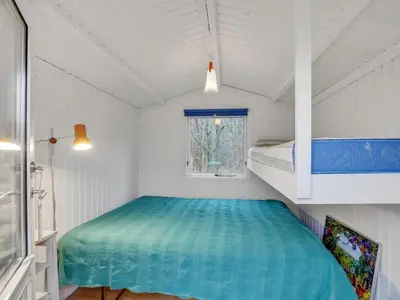 a bedroom with a bed and a bunk bed at Holiday Home Akke - 150m to the fjord by Interhome in Spottrup