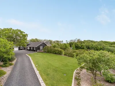 a house with a driveway and a grass yard at Holiday Home Regnwald - 400m to the fjord by Interhome in Spottrup