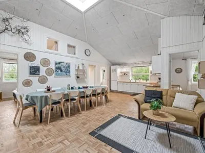 a living room with a table and a couch at Holiday Home Veijo - 400m to the fjord by Interhome in Spottrup