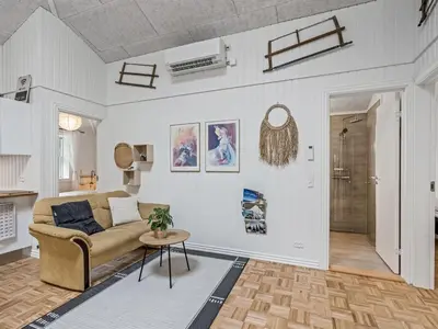 a living room with a couch and a table at Holiday Home Veijo - 400m to the fjord by Interhome in Spottrup