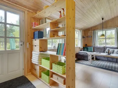 a room with wooden walls and a book shelf at Holiday Home Blome - 150m to the fjord by Interhome in Højslev