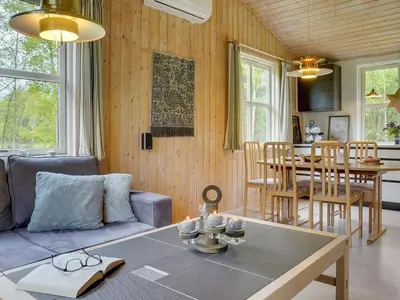 a living room with a couch and a table at Holiday Home Blome - 150m to the fjord by Interhome in Højslev