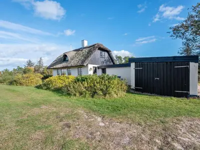 an old house with a thatched roof and a yard at Holiday Home Tordis - 250m to the fjord by Interhome in Roslev