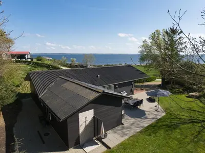 an overhead view of a building with a table and umbrella at Holiday Home Elissa - 50m to the fjord by Interhome in Roslev