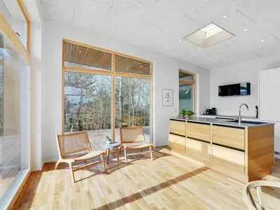 a kitchen with two chairs and a sink and a counter at Holiday Home Haubert - 500m to the fjord by Interhome in Lihme