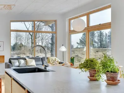 a kitchen with a sink and large windows at Holiday Home Haubert - 500m to the fjord by Interhome in Lihme