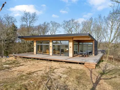 a house on a hill with a wooden deck at Holiday Home Haubert - 500m to the fjord by Interhome in Lihme