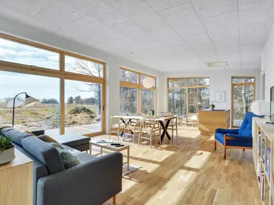 a living room with a couch and a table at Holiday Home Haubert - 500m to the fjord by Interhome in Lihme