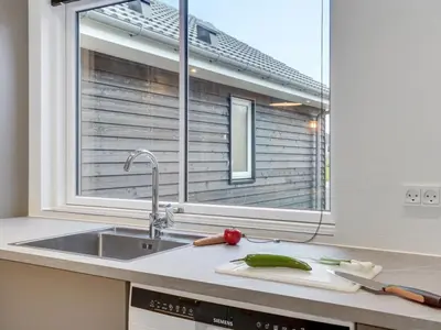 a kitchen with a sink and a window at Holiday Home Sibbe - 500m to the fjord by Interhome in Spottrup