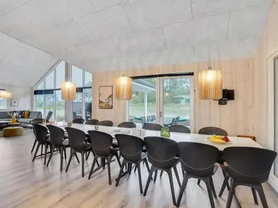 a large dining room with a large table and chairs at Holiday Home Sibbe - 500m to the fjord by Interhome in Spottrup