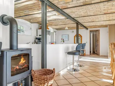 a fireplace in a living room with a stove at Holiday Home Kara - 100m to the fjord by Interhome in Fur