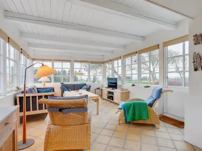 a living room with a table and chairs at Holiday Home Althea - 750m to the fjord by Interhome in Fur