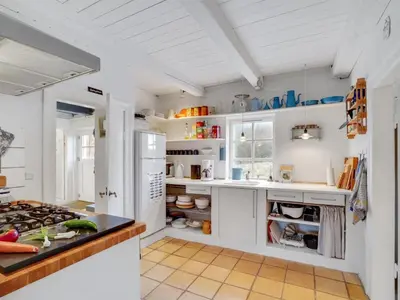 a kitchen with white cabinets and a white refrigerator at Holiday Home Althea - 750m to the fjord by Interhome in Fur