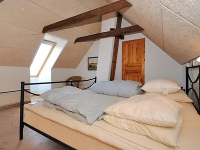 a bed with two pillows on it in a room at Holiday Home Alois - 1km to the fjord by Interhome in Hesselbjerg