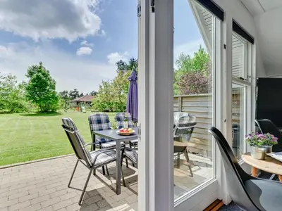 a patio with a table and chairs on a porch at Holiday Home Femija - 500m to the fjord by Interhome in Roslev