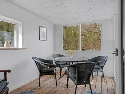 a dining room with a table and chairs at Holiday Home Thyra - 500m to the fjord by Interhome in Fur