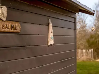 a wooden sign on the side of a house at Holiday Home Thyra - 500m to the fjord by Interhome in Fur